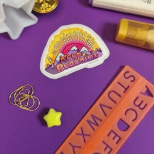 Keep reaching die cut sticker with sunset and mountains, white gloss vinyl with liquid lamination perfect for laptops, water bottles or other customisation. Locally made and illustrated by Smiley1starrs